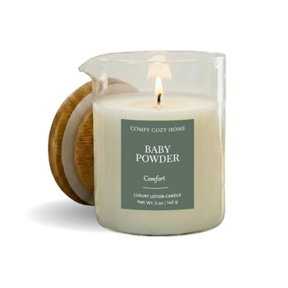 Candle labeled 'Baby Powder' from 'Comfy Cozy Home' with a wooden coaster on a white background