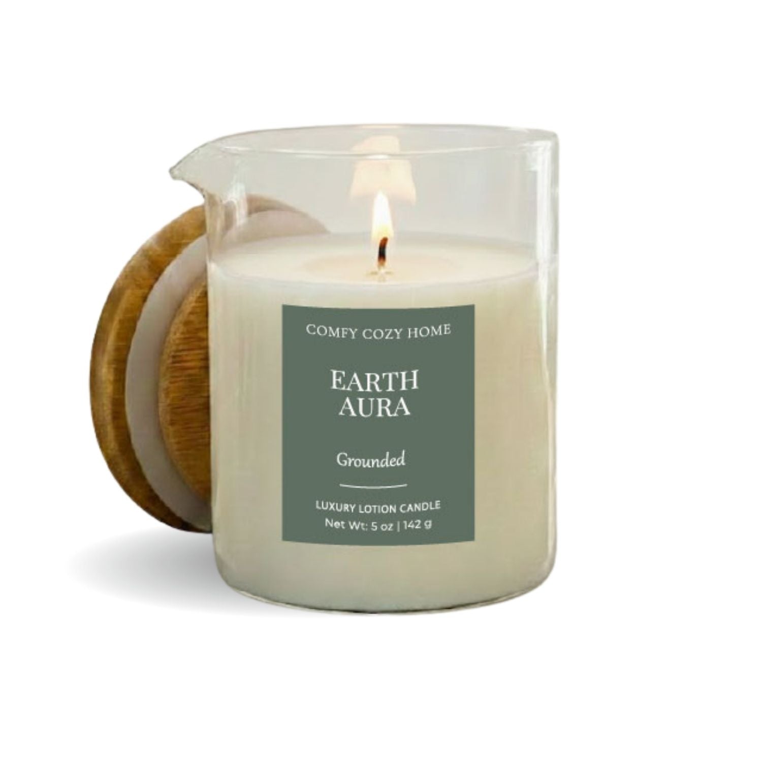 Candle labeled 'Earth Aura' from 'Comfy Cozy Home' with a wooden coaster on a white background