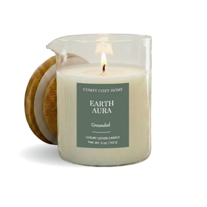 Candle labeled 'Earth Aura' from 'Comfy Cozy Home' with a wooden coaster on a white background