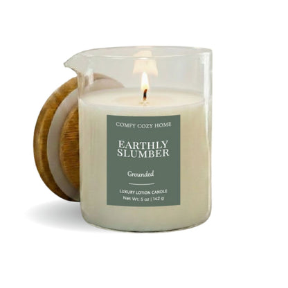 Candle labeled 'Earthly Slumber' by Comfy Cozy Home with a wooden coaster on a white background