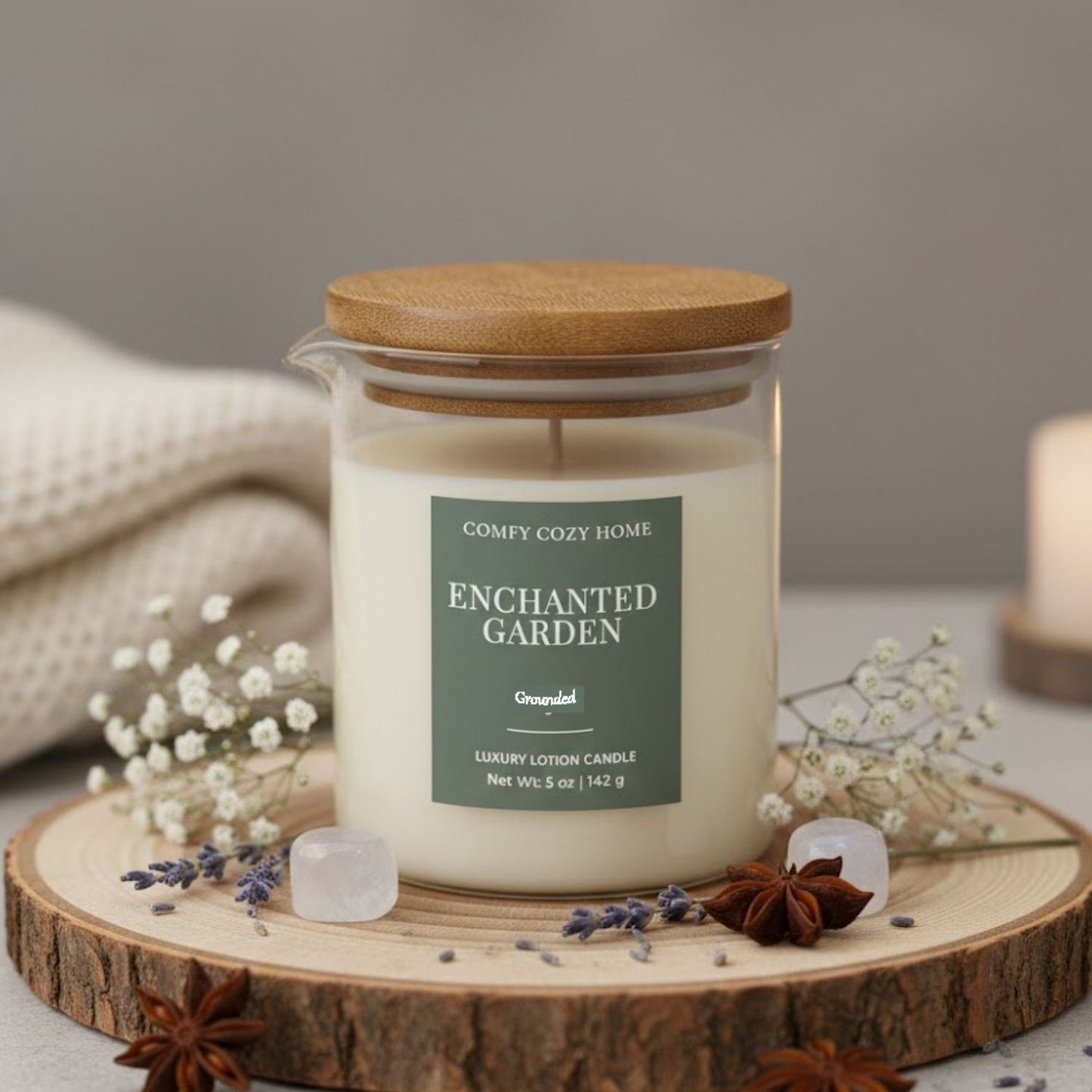 Candle labeled 'Enchanted Garden' on a wooden coaster with decorative elements.