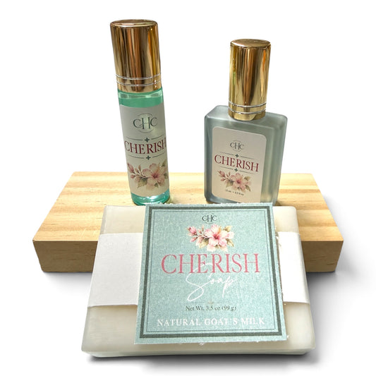 Cherish Scent Trio Gift Set in Freesia & Lilac: alcohol-free perfume spray, roll-on perfume and goat milk soap on a wooden soap dish