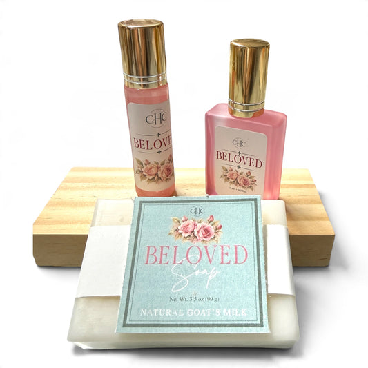Beloved Scent Trio Gift Set in Fresh Cut Roses: alcohol-free perfume spray, roll-on perfume and goat milk soap on a wooden soap dish