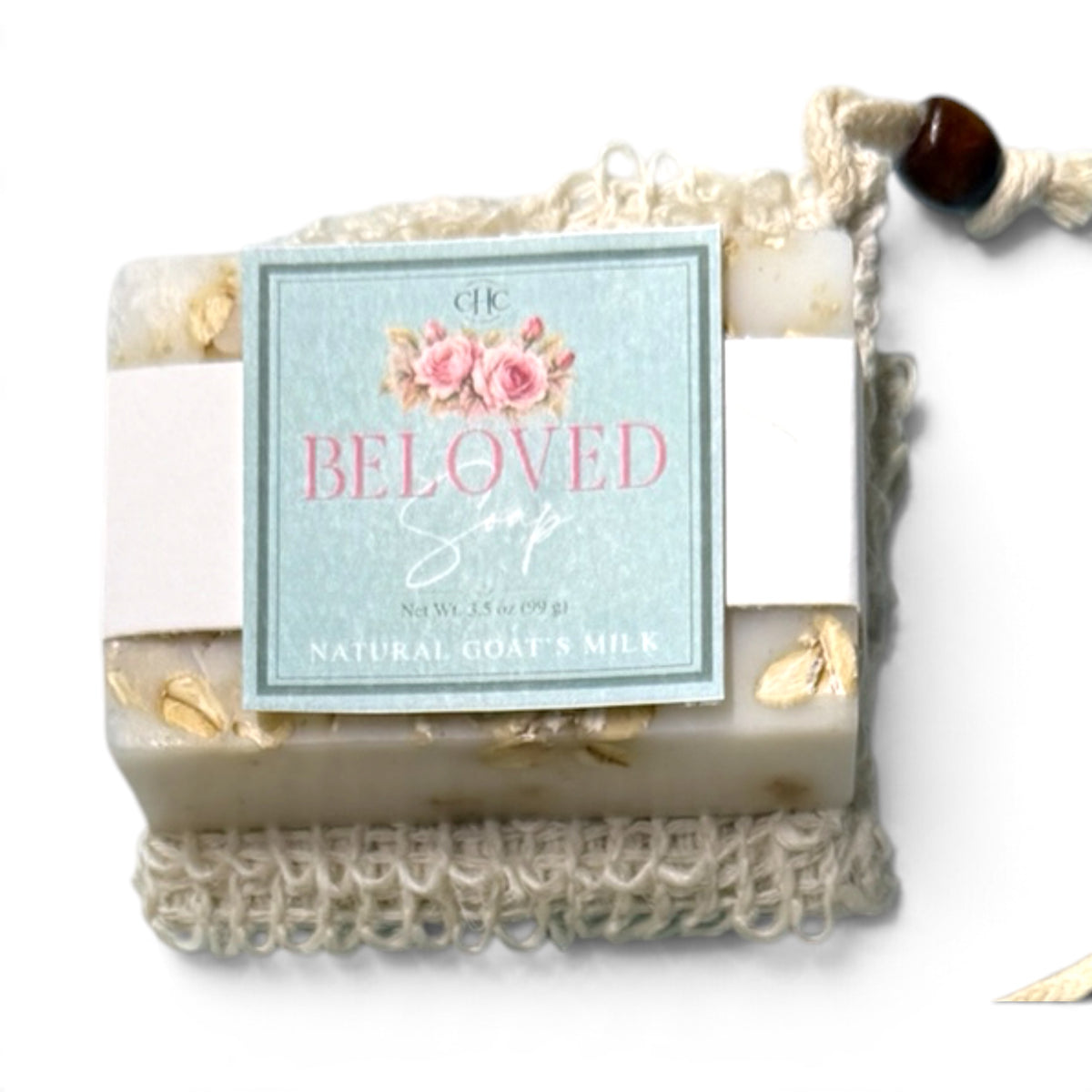 Beloved goat milk soap in Fresh Cut Roses tucked in its drawstring soap bag