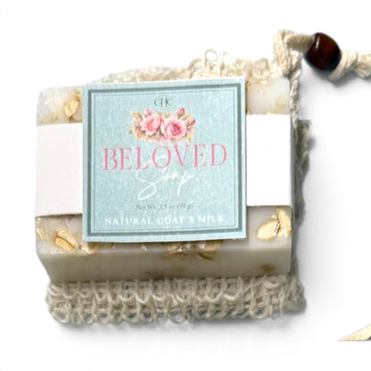 Beloved goat milk soap in Fresh Cut Roses tucked in its drawstring soap bag
