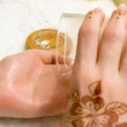 Hand with henna design applying massage candle oil form comfy cozy home to another hand